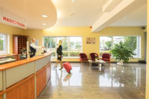 a lobby of a hospital with a woman waiting at the counter at Hotel Bettstadl in Landshut