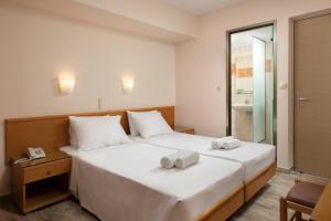 a bedroom with a bed with two towels on it at Nafsika Hotel in Rhodes Town