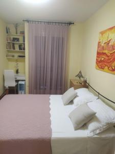 a bedroom with two white beds and a purple curtain at Noemi Apartment in Zadar