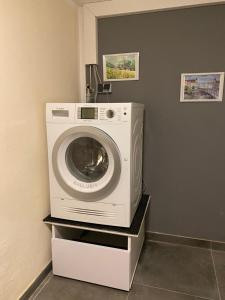 a washing machine sitting on a shelf in a room at Hotel Bettstadl in Landshut