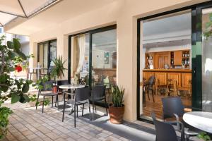 a patio with tables and chairs in a restaurant at Nafsika Hotel in Rhodes Town