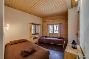 a bedroom with two beds and a window at BONNE NEIGE in La Daille
