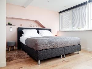 a bedroom with a large bed in a room at M&M Studio's 1 & 2 in Zandvoort