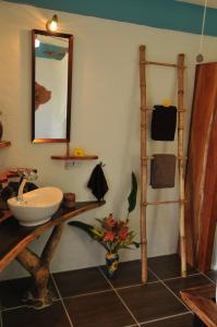a bathroom with a sink and a mirror at Mango Island Lodges in Saint Joseph