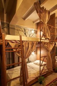 a bedroom with two bunk beds in a room at Happiness Community Wake & Bake Hostel - Rooftop Bar & Bistro in Pattaya