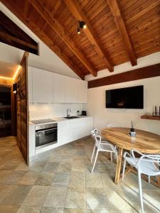 una cucina e una sala da pranzo con soffitto in legno di Chalet Mont Blanc de Courmayeur a Courmayeur