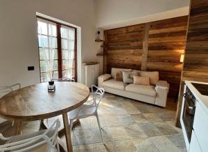 a living room with a table and a couch at Chalet Mont Blanc de Courmayeur in Courmayeur