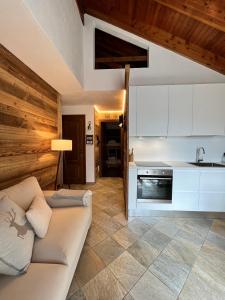 a living room with a couch and a kitchen at Chalet Mont Blanc de Courmayeur in Courmayeur
