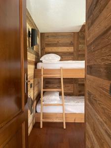 a room with two bunk beds and a door at Chalet Mont Blanc de Courmayeur in Courmayeur