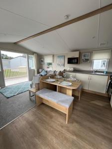 a living room with a table and a couch at 39 Woodland Walk in Pevensey