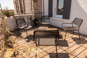four chairs and a table on a patio at Logis Hôtel La Chaize in Noirmoutier-en-l'lle