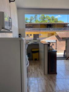 a kitchen with a view of a building with a window at buganvile hostel in Abraão