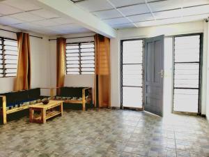 a room with a couch and a table and windows at 2 chambres dans un appartement avec vue sur la mer in Cotonou +10 photos