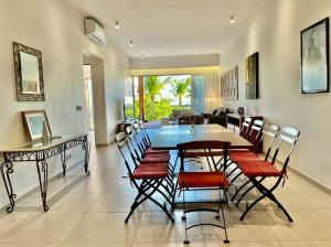 a dining room with a table and chairs at A Beachfront Haven - Ocean Point B2 in Pointe aux Piments