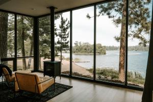 a living room with a view of the water at Nature Link Resorts in Nisswa