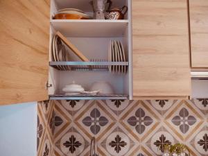 a kitchen cabinet with dishes and utensils in it at Casa Ling in Como