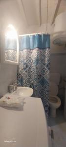 a bathroom with a sink and a toilet at Kioura's home in Ano Syros
