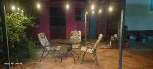 a table and chairs on a patio at night at Casa teocalli in Teotitlán del Valle
