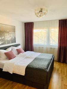 a bedroom with a large bed and a window at MILA-Appartement in Karlsruhe