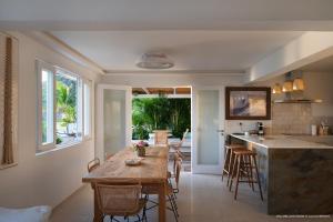 a kitchen and dining room with a wooden table at On the Beach , in Saint Barth... Mellow Mood Villa in Saint Barthelemy