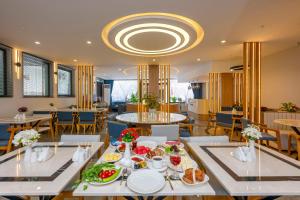 a dining room with a table with food on it at DIAMOND Luxury Hotel in Antalya