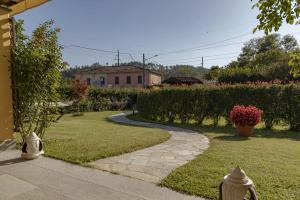 a garden with a walkway leading to a house at CàMia Lovely house ValDiVara 5Terre hiking in Sesta Godano