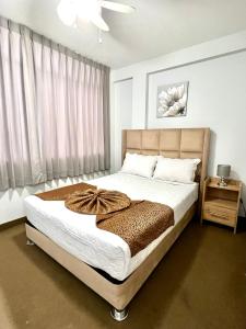 a bedroom with a large bed and a window at Costa Bella in Ilo