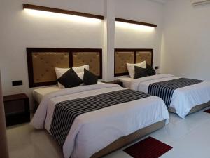 A bed or beds in a room at Four Points Resort - Anuradhapura