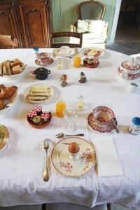 a table with plates of food on a white table cloth at Le Clos Saint Guilhem in Gerzat +12 photos