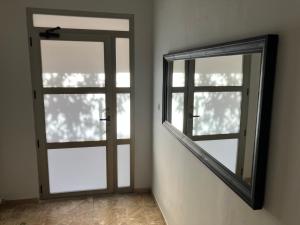 a mirror next to a door in a room at Alojamientos centro in Yecla