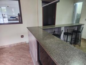 uma cozinha com um balcão de granito num quarto em vista do mar em Angra dos Reis