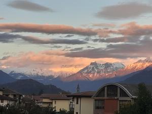a view of snow covered mountains under a cloudy sky at B&B Daniela in Darfo