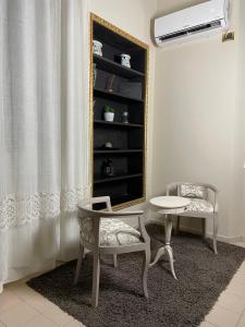 a room with a table and two chairs and a mirror at Seven boutique hotel in Sestri Levante