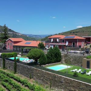 a villa with a swimming pool and a house at Quinta da Pitarrela in Peso da Régua