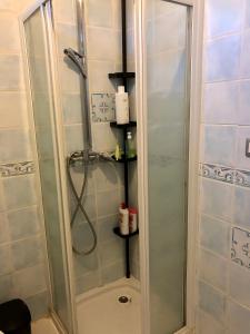 a shower with a glass door in a bathroom at Comme à la maison in Marsan