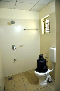 a bathroom with a toilet with a seat on it at MARHABA PALACE in Kozhikode