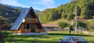 a house with a car parked in front of it at A Jahorina in Jahorina