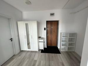 an empty room with a door and a wooden floor at Arini Cozy Corner in Şelimbăr