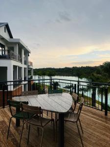 a table and chairs on a deck with a view of the water at 367 @ The Blyde in Pretoria