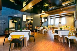 a restaurant with tables and white tables and chairs at Hotel Martina in Żnin +59 photos