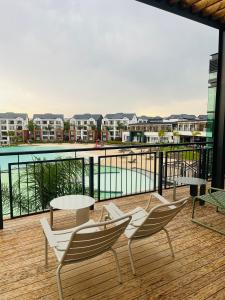a balcony with chairs and a table and a view of the water at 367 @ The Blyde in Pretoria