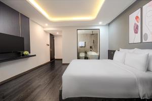 Postelja oz. postelje v sobi nastanitve Mercy Emerald Hotel