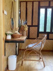 a chair in a room with a table and windows at Coffee and Resort in Ko Phayam