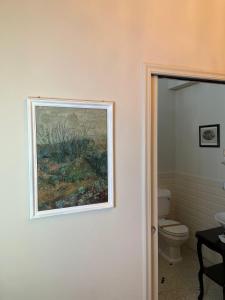 a painting on the wall of a bathroom with a toilet at Seven boutique hotel in Sestri Levante +52 photos