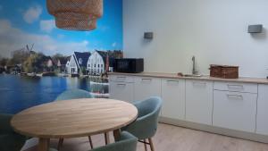 a kitchen with a table and a view of a river at BLRK 285 in Rotterdam