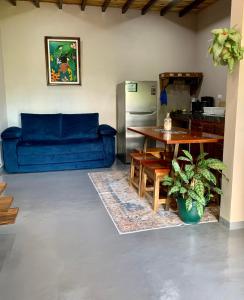 a living room with a blue couch and a table at Verde Amanecer in Bijagua