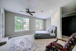 a bedroom with a bed and a ceiling fan at Golf course view vacation home in The Woodlands