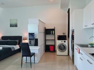 a kitchen and a living room with a washing machine at The Urban Getaway - 118 Tower View in Cyberjaya