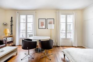 salon ze stołem i krzesłami w obiekcie Bel appartement à Ile saint Louis, Paris centre w Paryżu