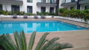 a swimming pool in front of a building at Embassy garden by Eric in Accra